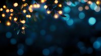 Glowing fairy lights with golden and turquoise bokeh effect against dark background create magical atmospheric mood for festive or romantic designs.