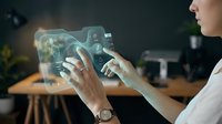 Young woman with light skin tone interacting with holographic display showing digital interface and data visualization in modern office workspace for technology and innovation concepts.