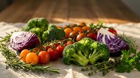 Fresh organic vegetables including broccoli, red cabbage, cherry tomatoes and herbs arranged on rustic wooden table for healthy cooking and meal preparation.