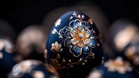 Decorative Easter egg with navy blue background and golden floral pattern featuring detailed flower ornaments and delicate swirls, traditional folk art style.