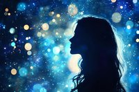 Silhouette of woman with long wavy hair against magical starry night sky with glowing blue bokeh lights and sparkles creating dreamy atmospheric background.