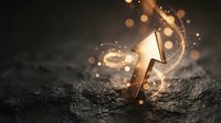 Golden trophy cup with magical sparkles and glowing light effects on dark textured surface for achievement and success concepts.
