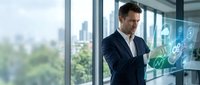 Professional businessman in dark suit interacting with futuristic holographic interface displaying digital icons in modern office with city skyline view.