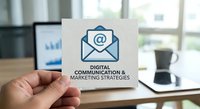 Digital communication and marketing strategies concept with email icon on business card held in modern office workspace for corporate branding.