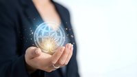 Businessman holding glowing digital globe with network connections in cupped hands representing global business technology and connectivity solutions.