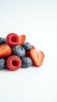 Fresh raspberries, blueberries and strawberries isolated on white background. Healthy organic berries for food, nutrition, wellness and culinary design projects.