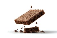 Broken chocolate brownie floating in air with crumbs scattered below on white background, isolated dessert photography for bakery and confectionery marketing.
