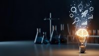 Glowing light bulb with innovation icons and business charts on dark background representing creative ideas and entrepreneurial success in modern workspace.
