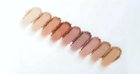 Makeup foundation swatches in various skin tones from light to dark beige brown displayed on white background for cosmetic color matching and beauty testing.