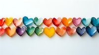 Colorful paper hearts arranged in rows on white background, creating festive border design for valentines, love themes, and romantic celebrations.