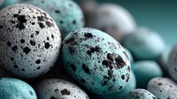 Speckled quail eggs in turquoise and gray tones arranged in artistic composition against teal background, creating natural texture for food photography.