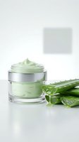 Natural aloe vera skincare cream in glass jar with fresh plant leaves on white background for cosmetic and beauty product marketing.