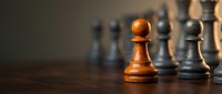 Golden wooden pawn stands out among silver chess pieces on dark board, symbolizing leadership, strategy, and competitive advantage in business and success.