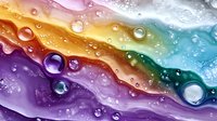 Abstract rainbow liquid waves with water droplets and bubbles creating colorful flowing pattern for modern design backgrounds and creative projects.