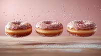 Pink glazed donuts with sprinkles floating in air against pastel background. Sugar powder falling creates magical atmosphere on wooden surface. Sweet dessert levitation.