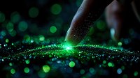 Finger touching glowing green particles creating magical light effect against dark background with bokeh circles. For fantasy and technology concepts.