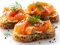 Smoked salmon and cream cheese on seeded bread slices garnished with fresh dill and black pepper, appetizing gourmet breakfast or party snacks.