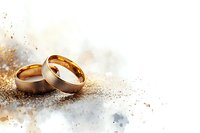 Golden wedding rings on abstract watercolor background with soft bokeh lights and glitter effects, symbolizing romance and eternal commitment.