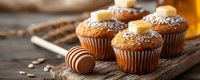 Fresh baked banana muffins with honey drizzle and powdered sugar on rustic wooden background, warm morning light creates cozy atmosphere.
