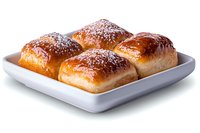 Fresh baked sweet buns with powdered sugar dusting served on white square ceramic plate against white background, isolated food photography.