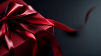 Elegant red satin ribbon bow with flowing streamer against dark background creates dramatic holiday mood. Luxurious gift wrapping detail for special occasions.