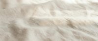 Soft beige fabric texture with natural wrinkles and folds creating gentle shadows and highlights for textile and fashion design backgrounds.