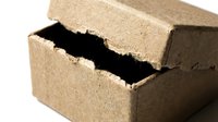 Cracked brown brick showing internal damage and structural weakness on white background isolated for construction and building material concepts.