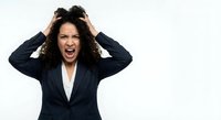 Frustrated businesswoman screaming with hands in hair showing stress and overwhelm in professional dark suit on white background.