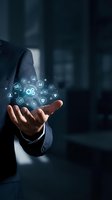 Businessman holding glowing digital icons representing technology, innovation and business solutions in modern corporate environment.