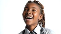 Young African American girl with braided hair laughing joyfully against white background, wearing school uniform with plaid tie. Perfect for education themes.