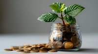 Small green plant growing from coins in glass jar symbolizing financial growth and investment success for savings and money management concepts.