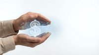 Hands holding glowing dollar sign symbol, representing financial growth, investment opportunities, and wealth management for business and finance concepts.