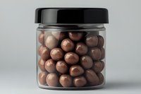 Glass jar filled with chocolate-covered nuts or candy balls against neutral background, minimalist product photography for food packaging and marketing materials.