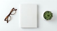 Minimalist workspace flat lay with blank white notebook, tortoiseshell eyeglasses and small succulent plant on clean white background for mockup designs.