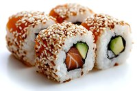 Fresh salmon and cucumber sushi rolls coated with white sesame seeds on white background, close up view showing texture and layers of Japanese cuisine.