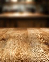 Empty wooden table surface with natural grain pattern and blurred warm background, suitable for product display and mockup presentations.
