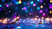 Magical glowing bokeh lights and sparkles on dark background with colorful blue and purple defocused circles creating dreamy festive atmosphere.