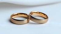 Pair of classic rose gold wedding bands on white background, showing matching rings with brushed metal finish and polished edges for wedding and engagement concepts.