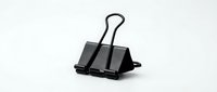 Black metal binder clip isolated on white background for office supplies and document organization needs.