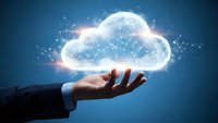 Businessman hand presenting glowing cloud computing network with connected dots and light effects on blue background for technology solutions.
