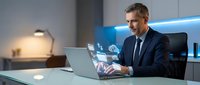 Professional businessman in dark suit working on laptop with holographic cloud computing interface in modern office environment for technology presentations.