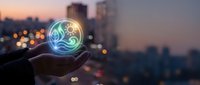 Hand holding glowing orb with yin yang symbol against blurred city skyline at dusk, representing balance, energy, and spiritual harmony for wellness and technology concepts.