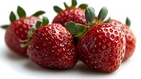 Fresh ripe strawberries with green leaves on white background, macro shot showing detailed texture and natural seeds pattern. Suitable for food packaging.