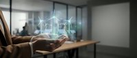 Businessman holding glowing wind turbine hologram in office, renewable energy technology concept for sustainable business and green power solutions.
