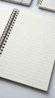 Open spiral notebook with blank lined pages on white surface, minimalist stationery flatlay for notes, planning, and education.