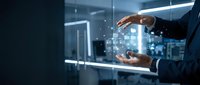 Businessman holding digital tablet with glowing network connections and data icons floating between hands in modern office environment for technology and business solutions.