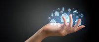 Smart home technology concept with hand holding glowing digital icons for automation, security, and connectivity solutions on dark background.