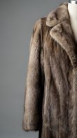 Luxurious brown mink fur coat on mannequin displaying premium texture and craftsmanship for high-end fashion and winter outerwear concepts.