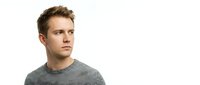 Caucasian male, approximately 25-35 years old, with light brown hair, wearing a gray crew neck sweater against white background. Suitable for business, lifestyle, and portrait projects.