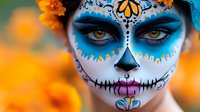 Vibrant Day of the Dead sugar skull makeup in blue and white with orange marigold flowers background, dramatic close up of eyes with artistic face paint design and details.